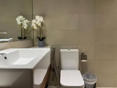 a bathroom with a white sink and a toilet at ASHRI luxurious apt in Meydan Riviera 44 in Dubai