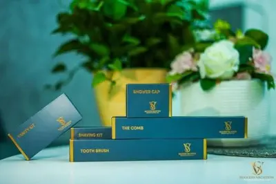 four blue and gold boxes on a table with a plant at Luxury apartment in Dubai marina 5 min walk to JBR Beach-3BHK Apartment in Dubai