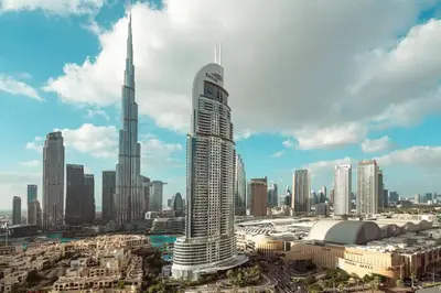 a view of a city with a tall skyscraper at Glow Sky Suite Trendy 1BR- Dubai Mall Access by Maxx Value Homes in Dubai