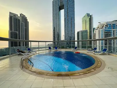 a swimming pool on the roof of a building with tall buildings at Unforgettable View & Experience Over Dubai Canal in Dubai