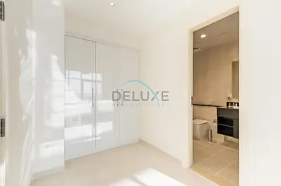 a white room with a sign that reads believe hollow house at Elegant 2BR in Tower 108 Jumeirah Village Circle by Deluxe Holiday Homes in Dubai