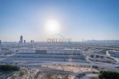 an aerial view of the dallas sign and freeway at Elegant 2BR in Tower 108 Jumeirah Village Circle by Deluxe Holiday Homes in Dubai