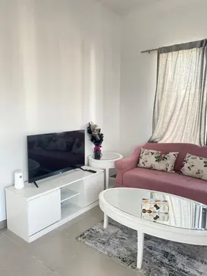 a living room with a couch and a tv at Lovely calm 3BR Apt Easy Accessibility to central Dubai with huge balcony and pool view Town Square in Dubai