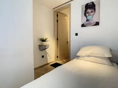 a bedroom with a bed with a mask on it at FIVE Palm Residence - Elegant Home in Dubai