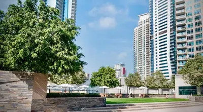 a park in a city with tall buildings at Gorgeous 2BR APT in Dubai Marina with Canal View in Dubai