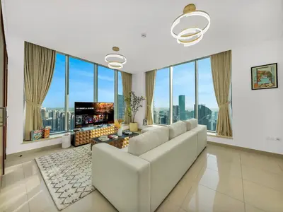 a living room with a white couch and large windows at New Downtown Setup - Penthouse with Panoramaic Views in Dubai