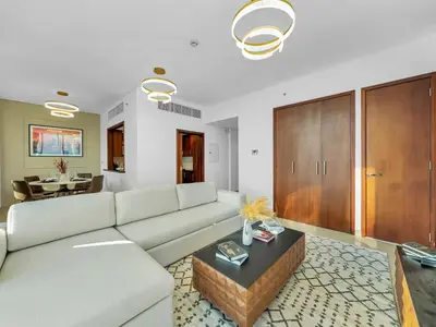 a living room with a couch and a table at New Downtown Setup - Penthouse with Panoramaic Views in Dubai