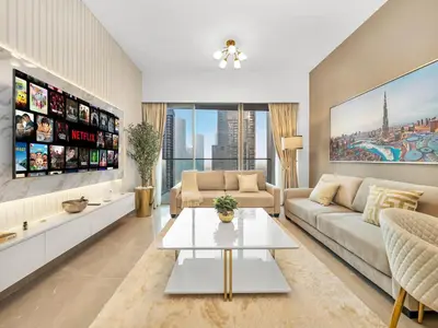a living room with a couch and a table at Luxury 1BR 5min to Dubai Mall Burj Khalifa View from pool in Dubai