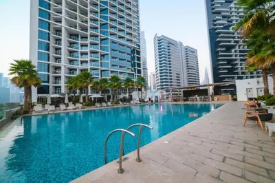 a swimming pool in a city with tall buildings at Luxury Studio Apartment in Prive By Damac B, Business Bay by Deluxe Holiday Homes in Dubai