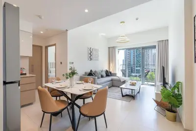 a kitchen and living room with a table and chairs at Stylish Urban Living - 1-bedroom in Burj Royale in Dubai