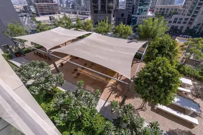 an overhead view of a park with trees and a tent at Stylish Urban Living - 1-bedroom in Burj Royale in Dubai