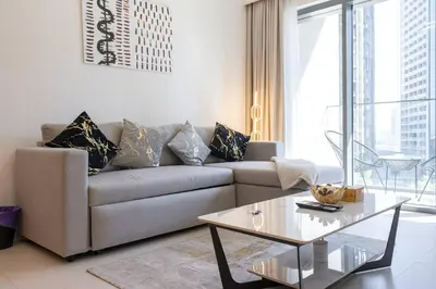 a living room with a couch and a coffee table at Stylish Urban Living - 1-bedroom in Burj Royale in Dubai