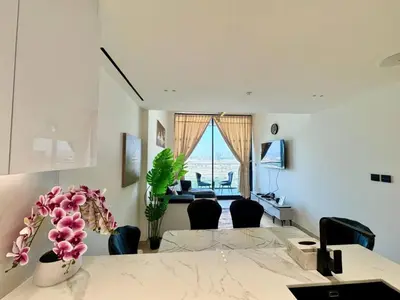 a room with a table and chairs and a desk at Cozy & Stylish 1br Apt Jvc Pool & Parking in Dubai