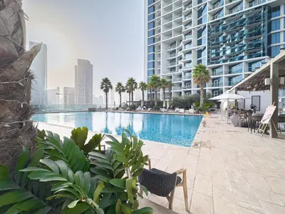 a swimming pool in the middle of a building at Escape24 Cozy Studio with Pool & Canal View near Burj Khalifa in Dubai