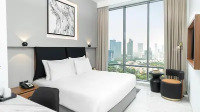 a bedroom with a white bed and a large window at Holiday Inn Dubai Jumeirah Village Circle by IHG in Dubai
