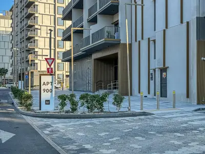 an empty street in a city with buildings at Lovely Studio in Mag 900, Meydan in Dubai