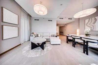 a living room with a couch and a table at Luxury 3BD study in Missoni with private elevator in Dubai