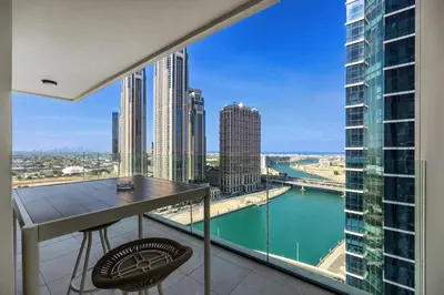 a balcony with a table and a view of the city at Luxury 3BD study in Missoni with private elevator in Dubai