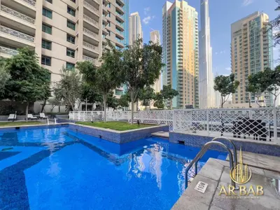 a swimming pool in the middle of a city with tall buildings at 29 Burj Boulevard - Premium 1BR - City Skyline view - Near Burj Khalifa - Downtown Dubai in Dubai