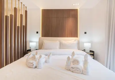 a bedroom with a bed with towels on it at Luxurious Studio with Stunning Burj Khalifa, Pool & Lake Views Steps from Dubai Mall in Dubai