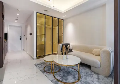 a living room with a couch and a table at Luxurious Studio with Stunning Burj Khalifa, Pool & Lake Views Steps from Dubai Mall in Dubai