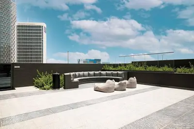a bench sitting on top of a building at 2BR with Extra-Large Balcony Canal & Burj Views by Vibel in Dubai