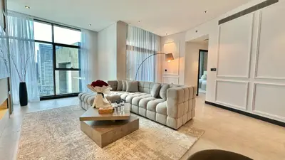 a living room with a couch and a table at 2BR with Extra-Large Balcony Canal & Burj Views by Vibel in Dubai