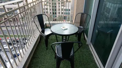 a table and two chairs on a balcony at Boho Chic Haven Burj Khalifa view in Dubai