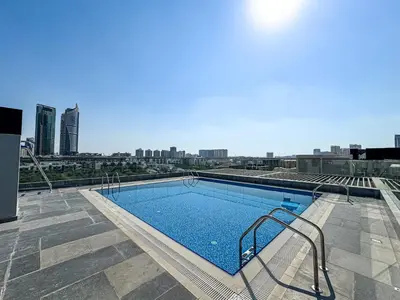 a swimming pool on the roof of a building at Stylish Studio APT with Pool and Gym in Dubai
