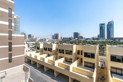 an apartment building with a view of the city at Stylish Studio APT with Pool and Gym in Dubai