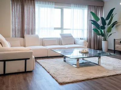 a living room with a couch and a coffee table at DreamShoma- Deluxe 1BR With Lake View in Dubai