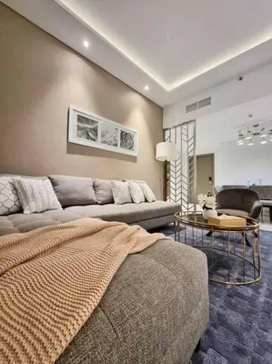a living room with a couch and a table at 2 Bedroom DAMAC Prive Apartment in Dubai