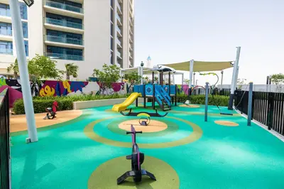 a playground with a slide and a play equipment at ALiving Elegant 2BR plus Maid's Room I Aykon City, Business Bay- 4016 in Dubai