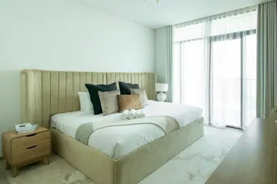 a bedroom with a large bed with a large window at Waves - Luxurious 11th Floor Retreat in Palace Residences in Dubai