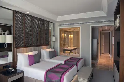 a hotel room with a bed and a bathroom at Taj Dubai in Dubai