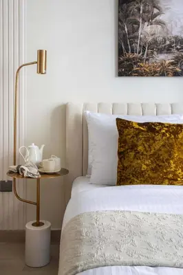 a bedroom with a bed and a side table at Frank Porter - Azizi Riviera 28 in Dubai