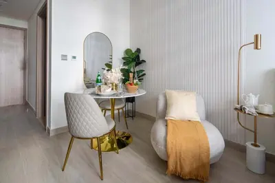 a dining room with a table and a mirror at Frank Porter - Azizi Riviera 28 in Dubai