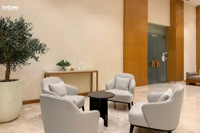 a waiting room with three chairs and a table at bnbme - Chic Downtown Studio Near Burj Khalifa Dubai Mall w Pool Gym Concierge in Dubai