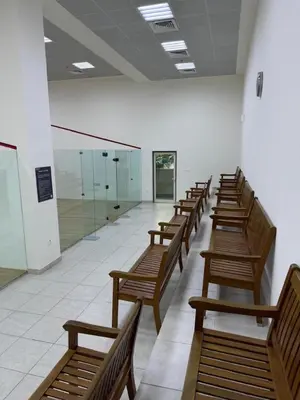 a row of wooden benches in a large room at Marina Quays West - Modern One Bedroom in Marina in Dubai