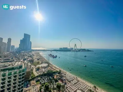 a view of a beach with a ferris wheel in the water at HiGuests - Beachside Oasis Stylish 2BR Apartment in La Vie in Dubai