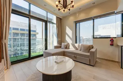 a living room with a couch and a table at Chic 1 Bed Oasis in Azizi Riviera in Dubai