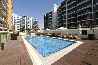 a swimming pool in the middle of a building at Chic 1 Bed Oasis in Azizi Riviera in Dubai