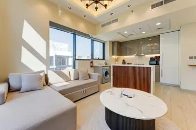 a living room with a couch and a table at Chic 1 Bed Oasis in Azizi Riviera in Dubai