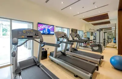 a gym with treadmills and elliptical machines at The Skyline Suite Luxury Downtown Retreat in Dubai
