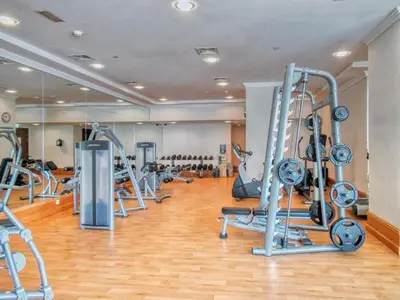 a gym with a bunch of treadms and machines at Artistic Retreat in JBR with Private Beach Access in Dubai
