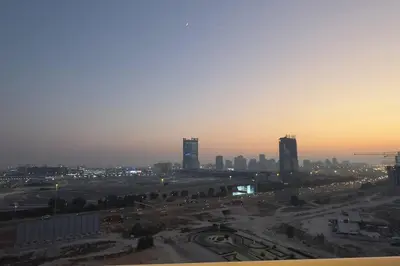a view of a city at sunset with buildings at Stylish Studio With Amazing View in Dubai