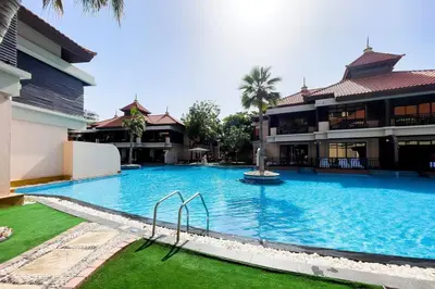 a large swimming pool in front of a building at Palm Jumeirah Sea View 1Bdr in Dubai