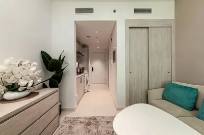 a living room with a couch and a chair at Private Beach Palm Jumeirah Studio high floor in Dubai