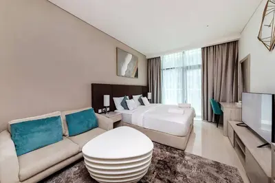 a hotel room with a bed and a couch at Private Beach Palm Jumeirah Studio high floor in Dubai