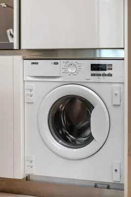 a white washing machine sitting in a kitchen at Downtown Studio Sterling WEST in Dubai
